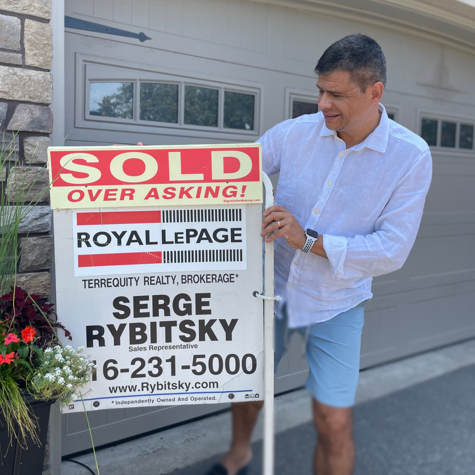 serge-holds-sold-sign